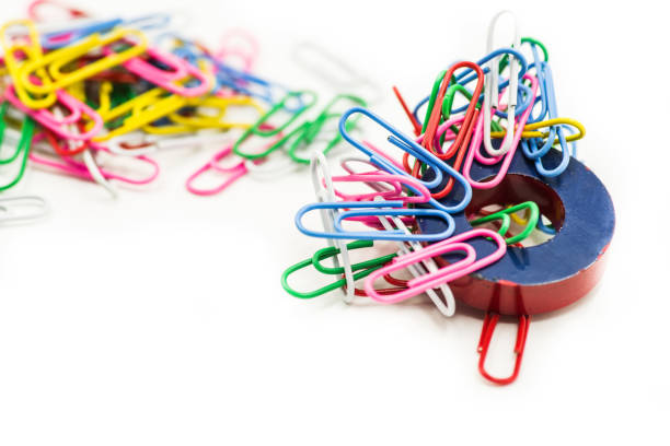 Magnet and colorful paper clips isolated on a white background