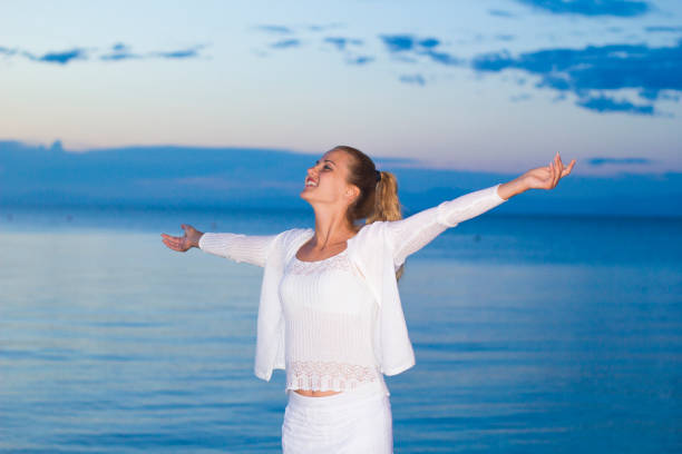 istock Dusk, woman at dock 911180222