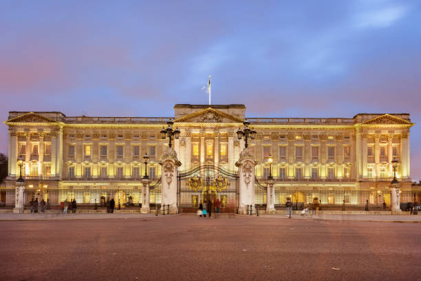Buckingham Palace in Westminster London UK Tourists look at the landmark Buckingham Palace in Westminster, London, UK at twilight. buckingham palace photos stock pictures, royalty-free photos & images