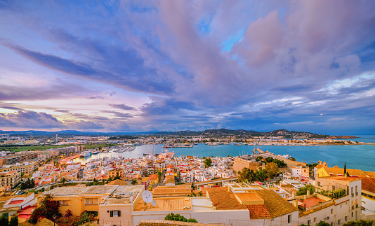 Elevated view over Ibiza Old Town and the harbour/ferry terminal at dusk
