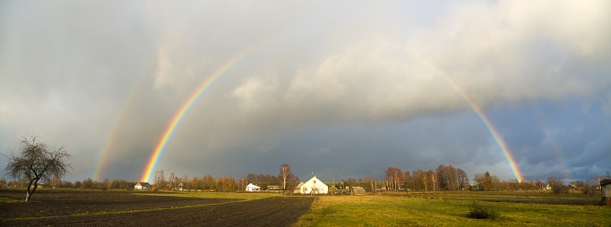 rainbow over the village houses and fields