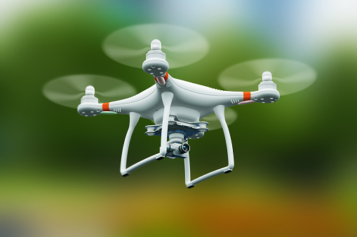 Quadcopter drone con cámara de vídeo de 4 K volando en el aire photo