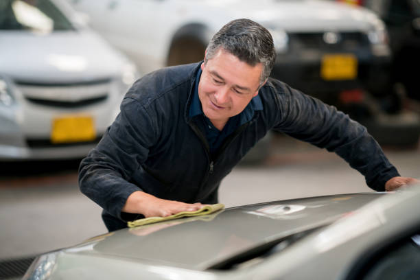 istock Man working at a car garage polishing the vehicles 911190238