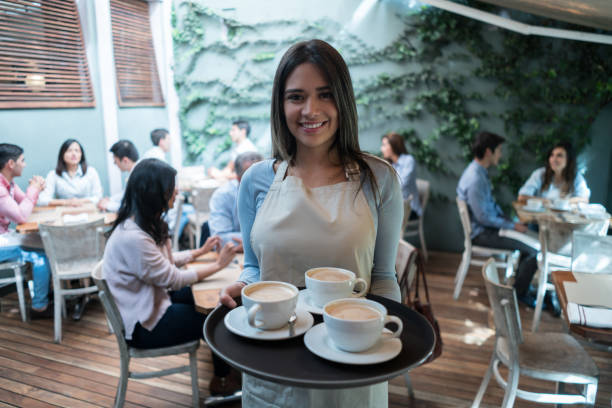 Portrait of a waitress working at a cafe serving coffee