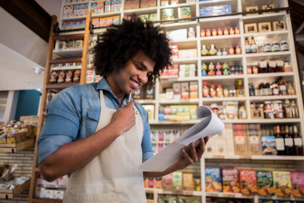 istock Man working at a grocery store doing the inventory 911190406