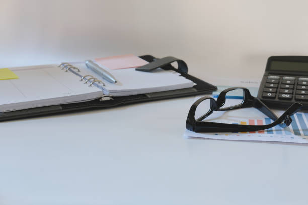 istock calculator, notebook on accountant desk. financial chart report on office business table 911192148