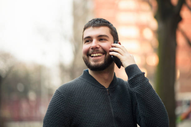istock Handsome young man talking on his phone in an urban area 911219224