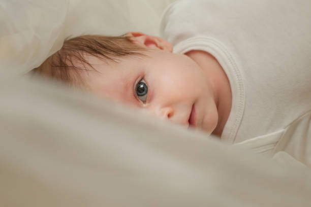 Baby peeking under the blanket