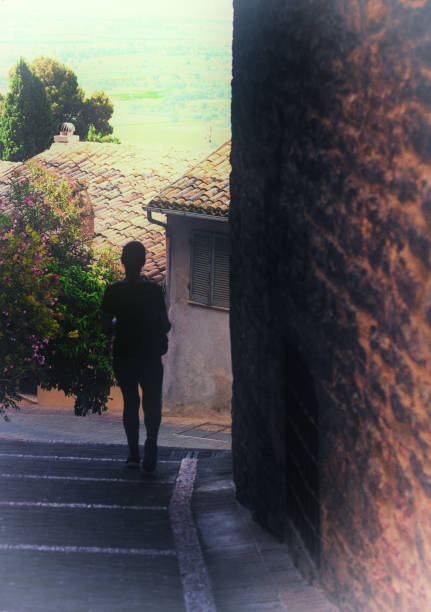 istock Assisi, Italy: Woman Descends Steps in Medieval Village 911224894