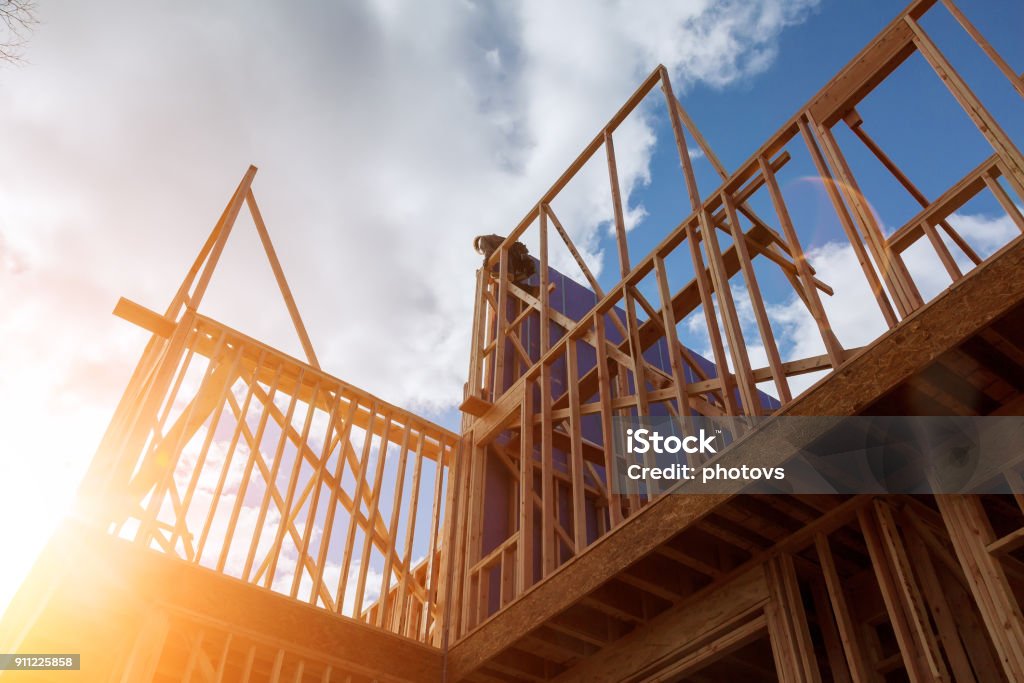 builder at work with wooden roof construction Wood Building frame Wood Building frame builder at work with wooden roof construction Construction Industry Stock Photo