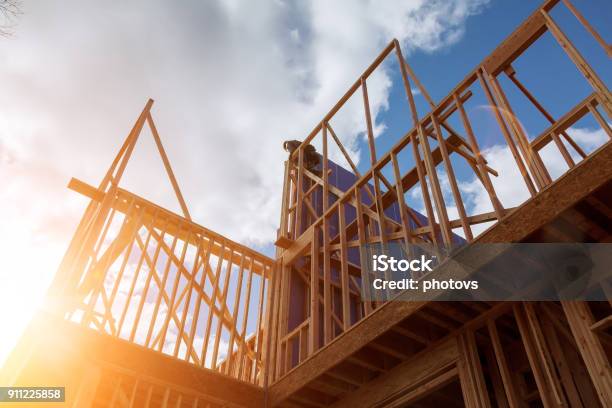 Builder At Work With Wooden Roof Construction Wood Building Frame Stock Photo - Download Image Now