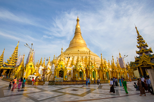 YANGON, MYANMAR - JANUARY 9, 2016: Unidentified tourists and locals people visit the Shwedagon Pagoda. Shwedagon Pagoda is the most sacred Buddhist pagoda for the Burmese