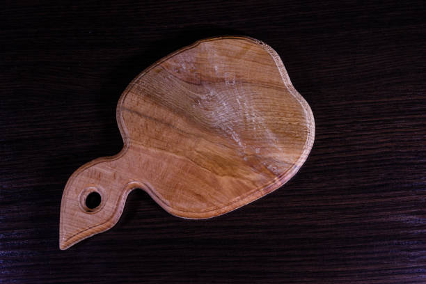 istock Cutting board on the dark wooden table. Top view 911226088