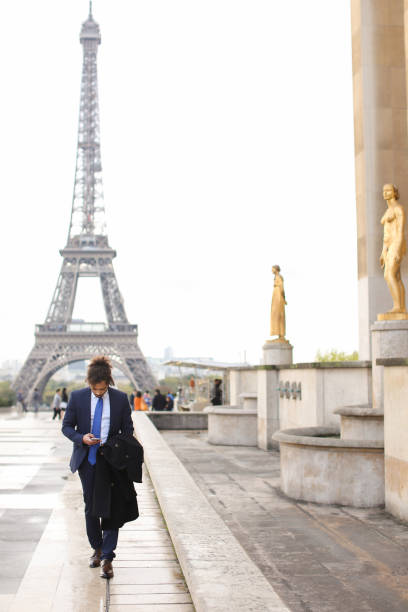 istock Hispanic journalist close to Eiffel Tower reading newspaper and 911234874