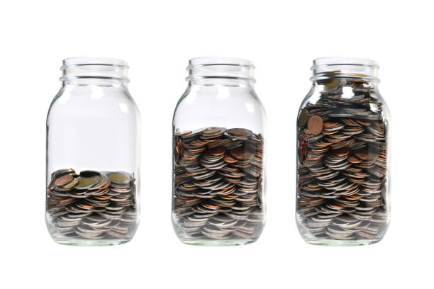Image of step of pile of coins in glass jar for business, saving, growth, economic concept isolated on white background Image of step of pile of coins in glass jar for business, saving, growth, economic concept isolated on white background deposit bottle stock pictures, royalty-free photos & images