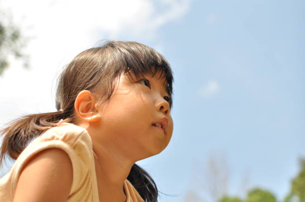 istock Girl's smiling in the blue sky 911243614