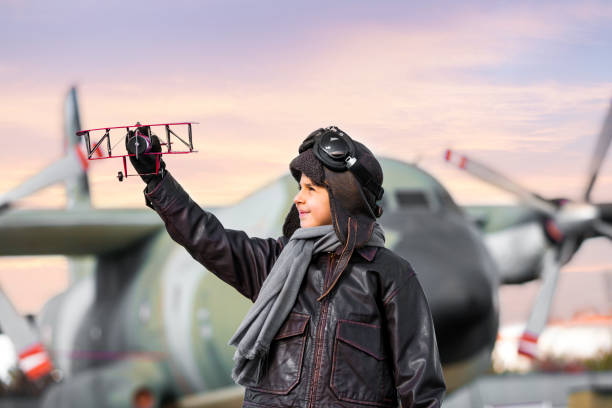 istock Boy playing with toy airplane 911246716
