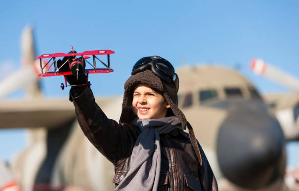 istock Boy playing with toy airplane 911246778