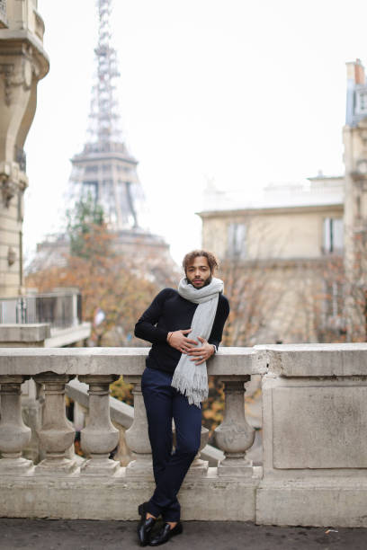 istock Young Black Man And His Motorcycle In Paris 911250158