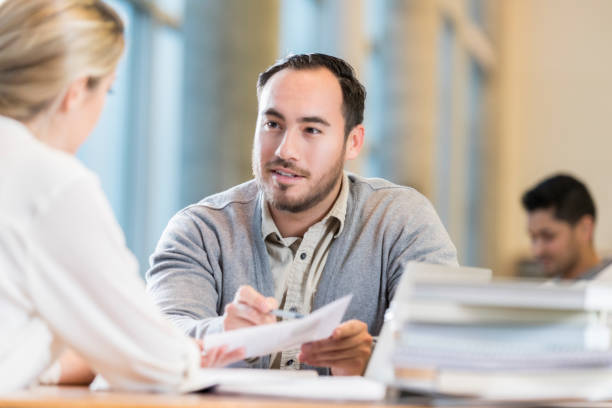 istock Male accountant discusses something with client 911250168