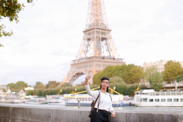istock Pretty female standing on street not far from Eiffel Tower and m 911252586