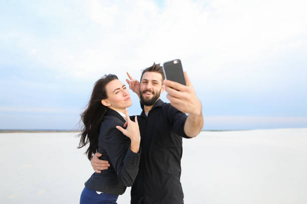 istock boyfriend and girlfriend testing front-camera in new smar 911252632