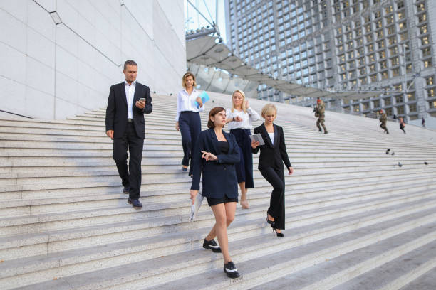 istock Financial team going down stairs in   with tablet, case and ta 911252832