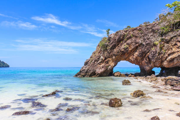 Stone arch at Khai Island, Tarutao National Park, Satun Province, Thailand Stone arch at Khai Island, Tarutao National Park, Satun Province, Thailand tarutao stock pictures, royalty-free photos & images
