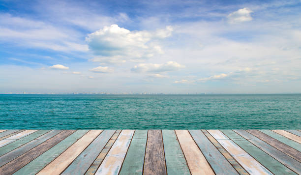 istock Wood table top with blurred nature scene tropical beach 911263152