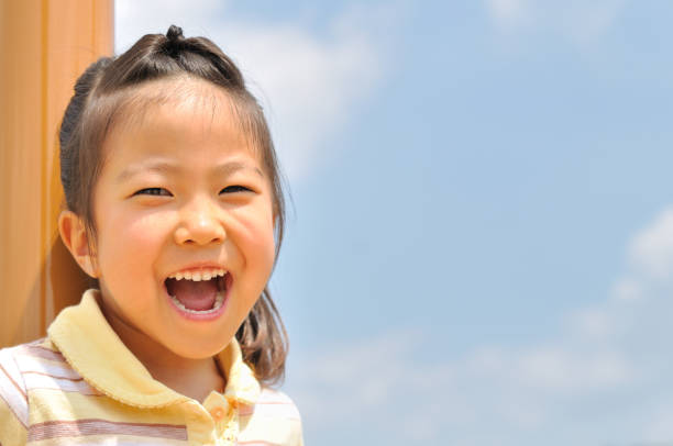 istock Girl's smiling in the blue sky 911267056