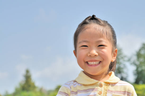 istock Girl's smiling in the blue sky 911267078