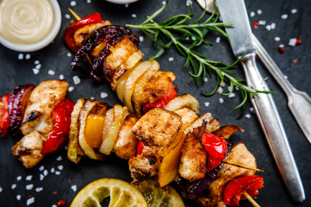 istock Kebabs - grilled meat and vegetables on wooden background 911270254