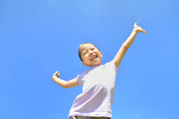 istock Girl's smiling in the blue sky 911270292