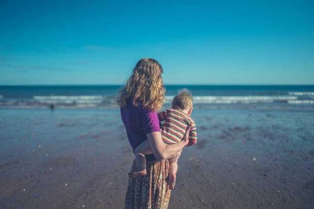 istock Mother with baby on the beach 911274836