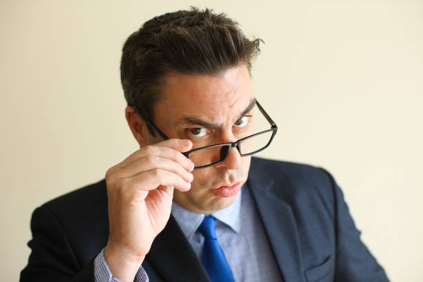 istock Intelligent businessman adjusting glasses 911278698