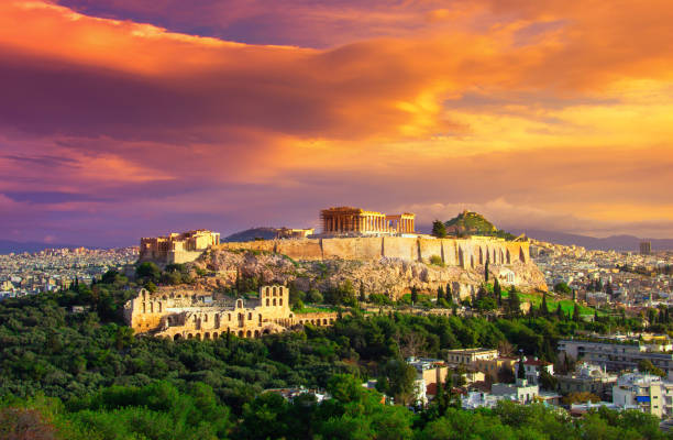 istock Acropolis with Parthenon. View through a frame with green plants, trees, ancient marbles and cityscape, Athens, Greece. 911281508