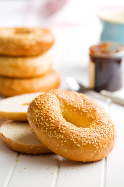 tasty bagel with sesame seed on white table