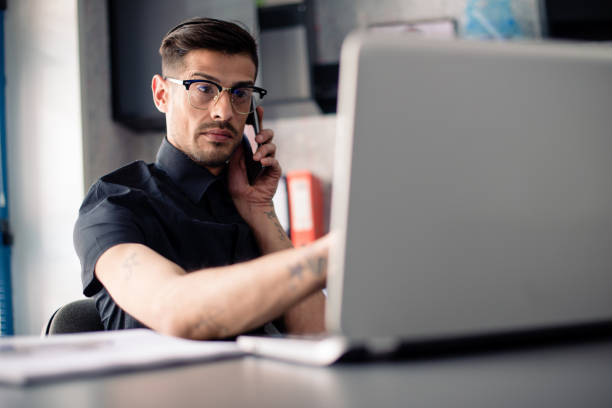 istock Businessman uses laptop and phone 911292154