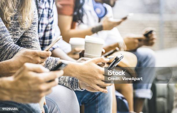 Multicultural Friends Group Using Smartphone With Coffee At University College Break People Hands Addicted By Mobile Smart Phone Technology Concept With Connected Trendy Millennials Filter Image Stock Photo - Download Image Now