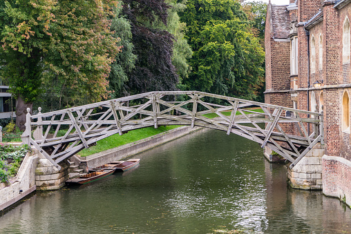 Punting on the river Cam and the Mathematical Bridge, Queens college, Cambridge in the depths of Autumn.