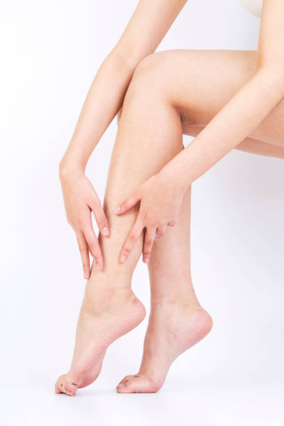 istock Studio shot of woman's hand touching leg 911298586