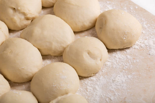 istock Pieces of dough prepared for baking pies. Close-up view 911301578
