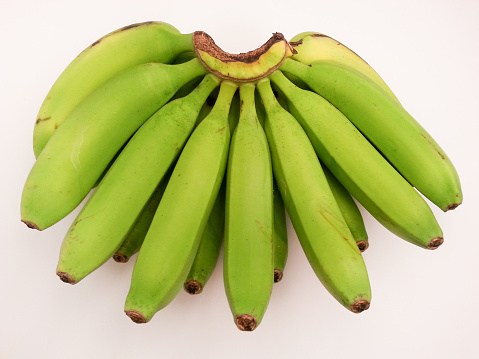 High angle view of green banana on white background