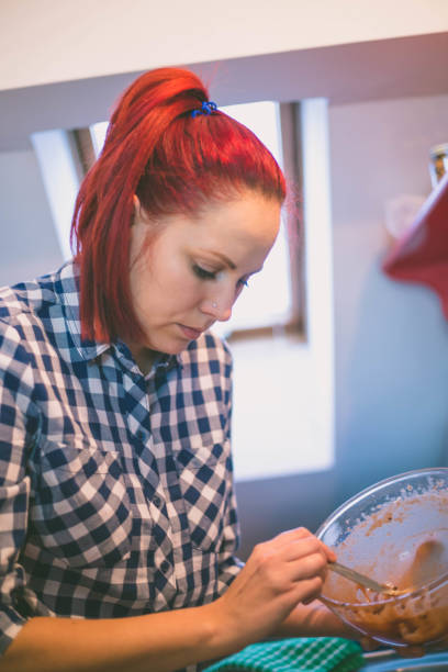 istock happy woman cooking on kitchen 911306356