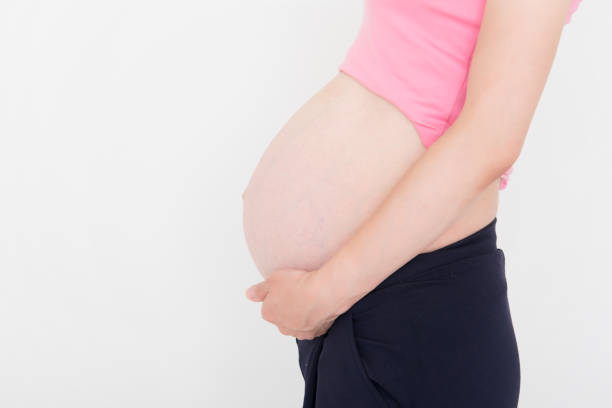 istock Pregnant woman on white background 911317832