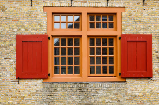 istock old red wooden window on brock wall 911321274