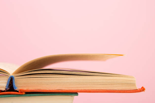 istock education and wisdom concept - open book on wooden table, color background 911322902