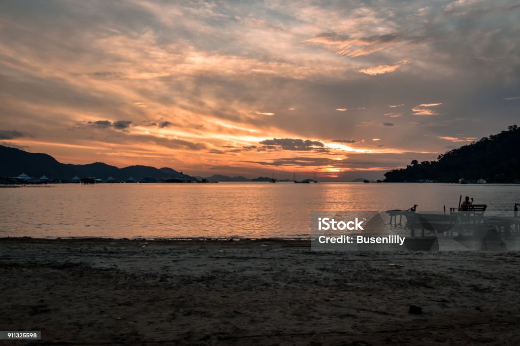 tropical sunrise with wooden jetty tropical sunrise with wooden jetty over island Backgrounds Stock Photo