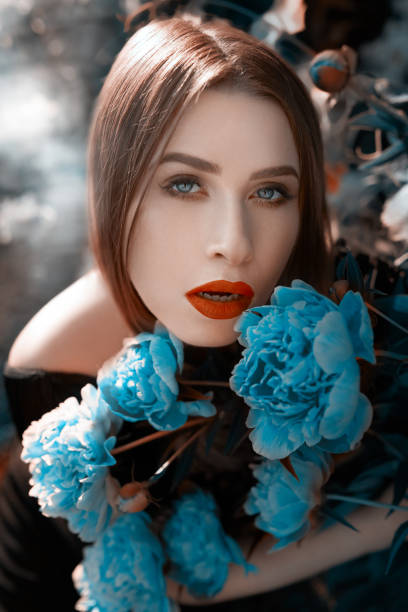 istock fashion model with blue flowers 911325838