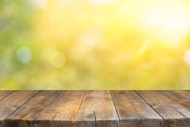 istock Empty table in front of blurry forest background. Ready for product display montage. 911325938